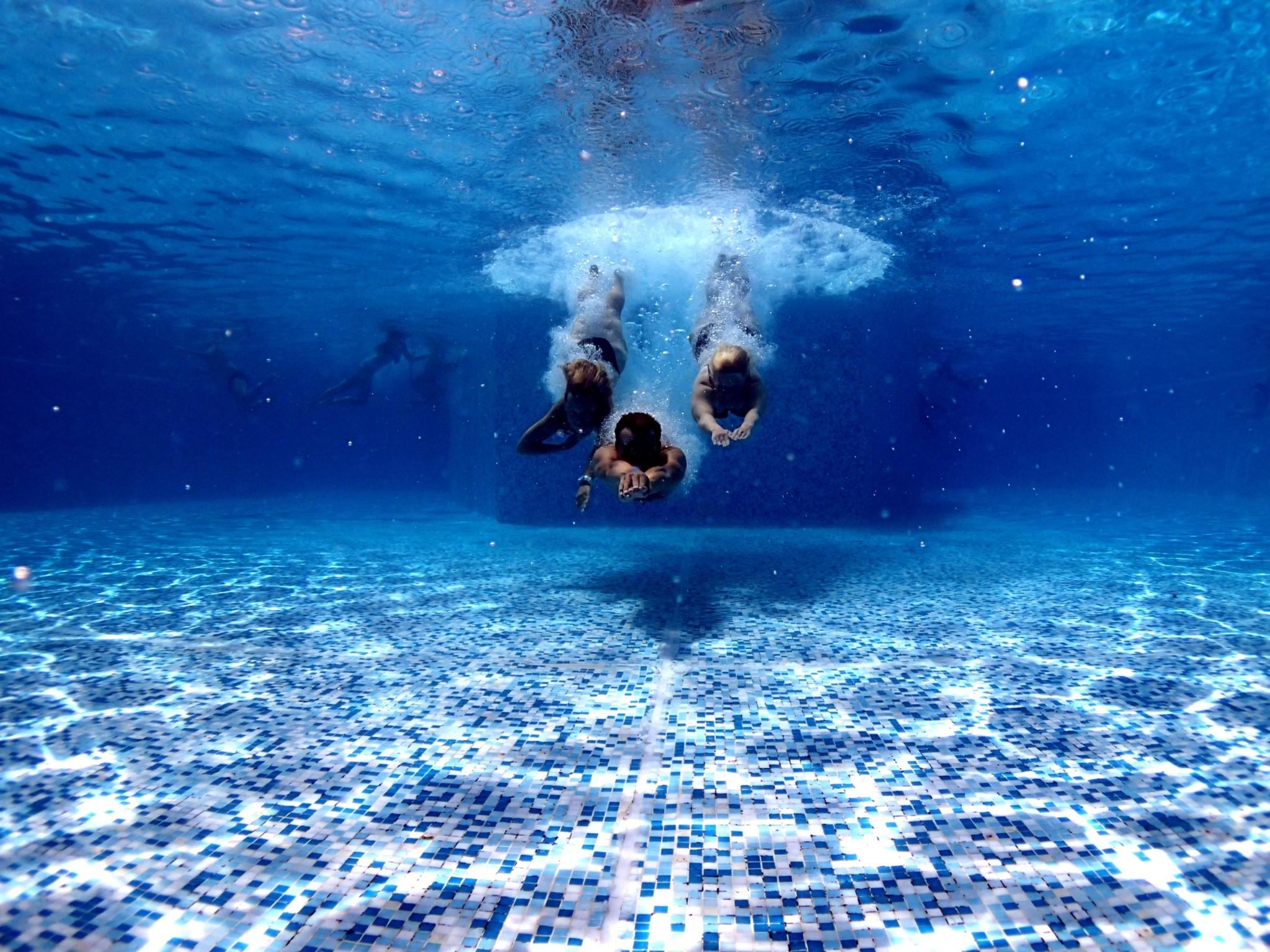 three people diving into water pool - Sensorex