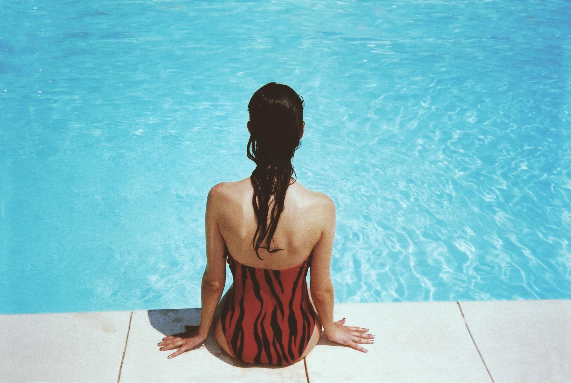 woman's back in swimming pool